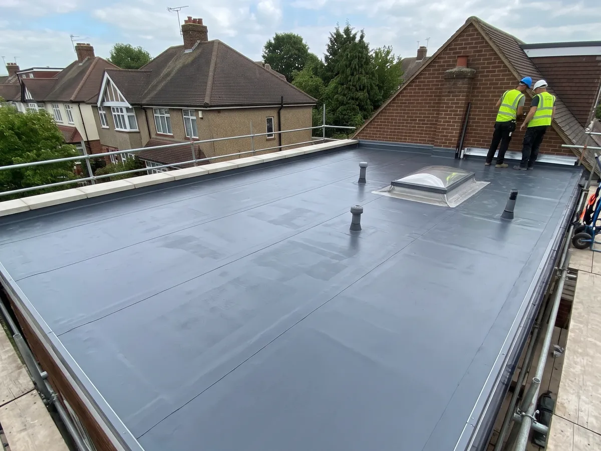 New rubber flat roof with a rooflight, finished on an extension