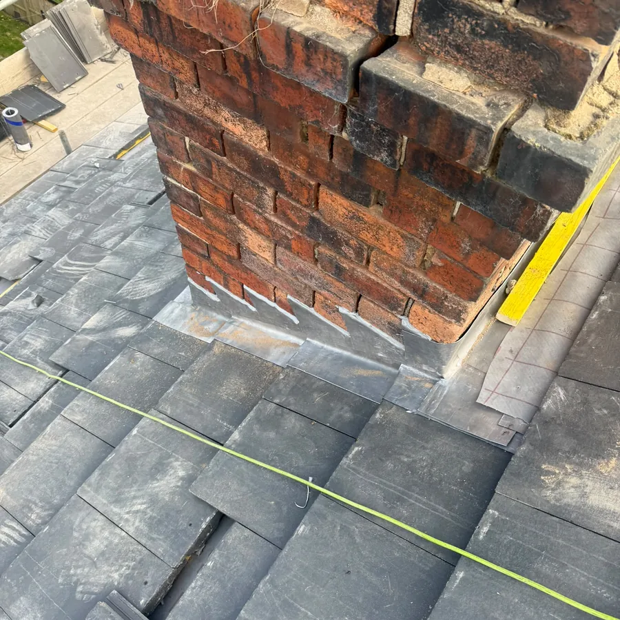 New lead flashing on a chimney during a re-roof
