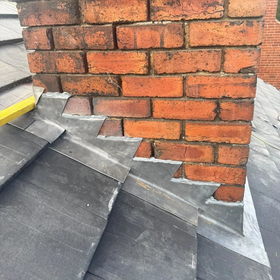 Stepped lead flashing and soakers on a chimney