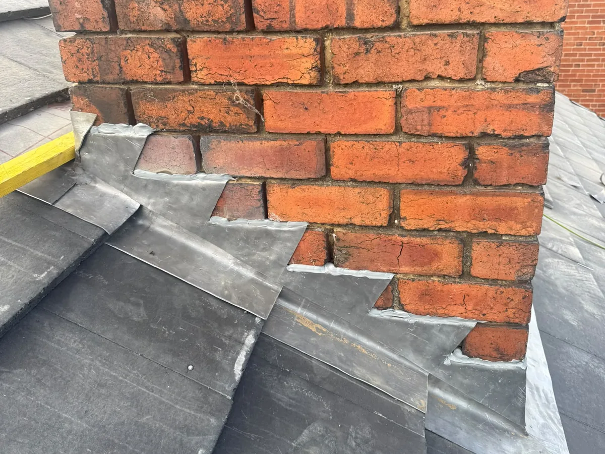 Stepped lead flashing and soakers on a chimney