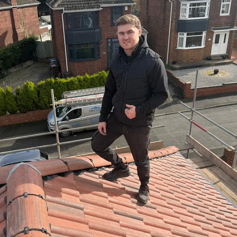 John Smith, owner of Taylored Roofing, on a finished red tiled roof