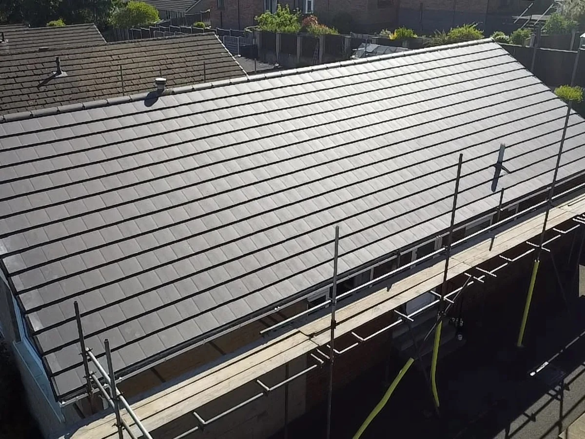 New grey tiled roof on a bungalow, scaffold still up