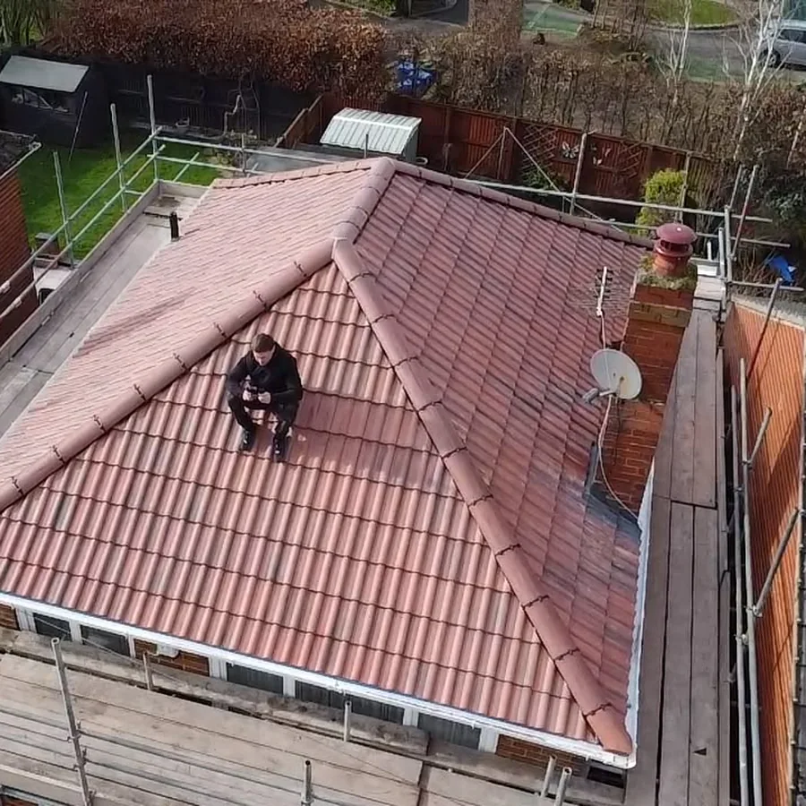 Hipped roof re-covered in red tiles, from the air