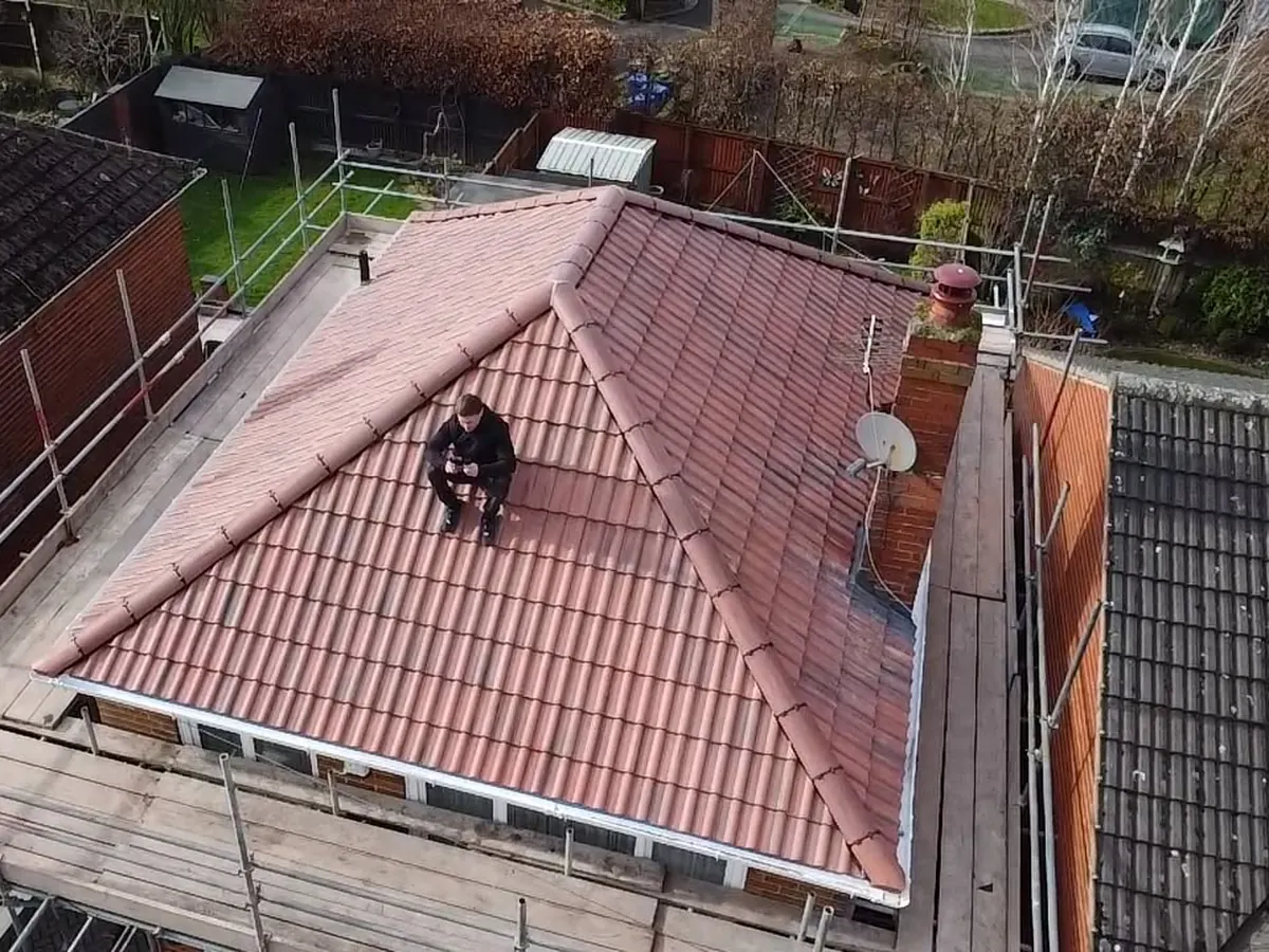 Hipped roof re-covered in red tiles, from the air